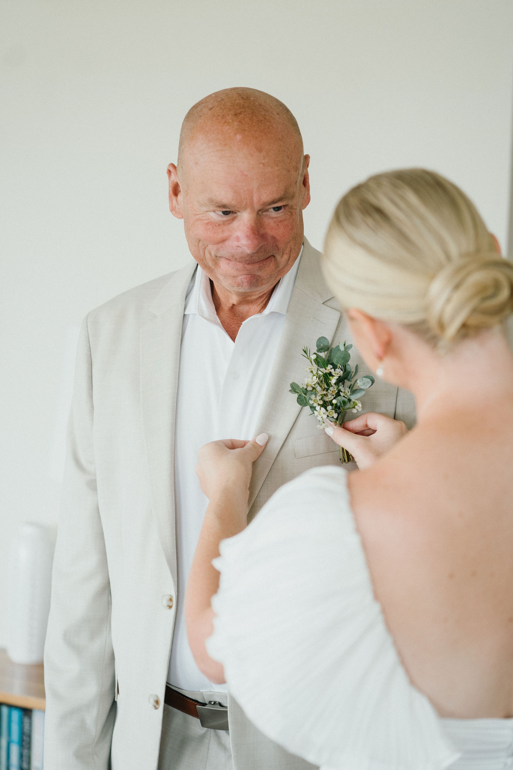 Father of the bride seeing his daughter in her dress for the first time.