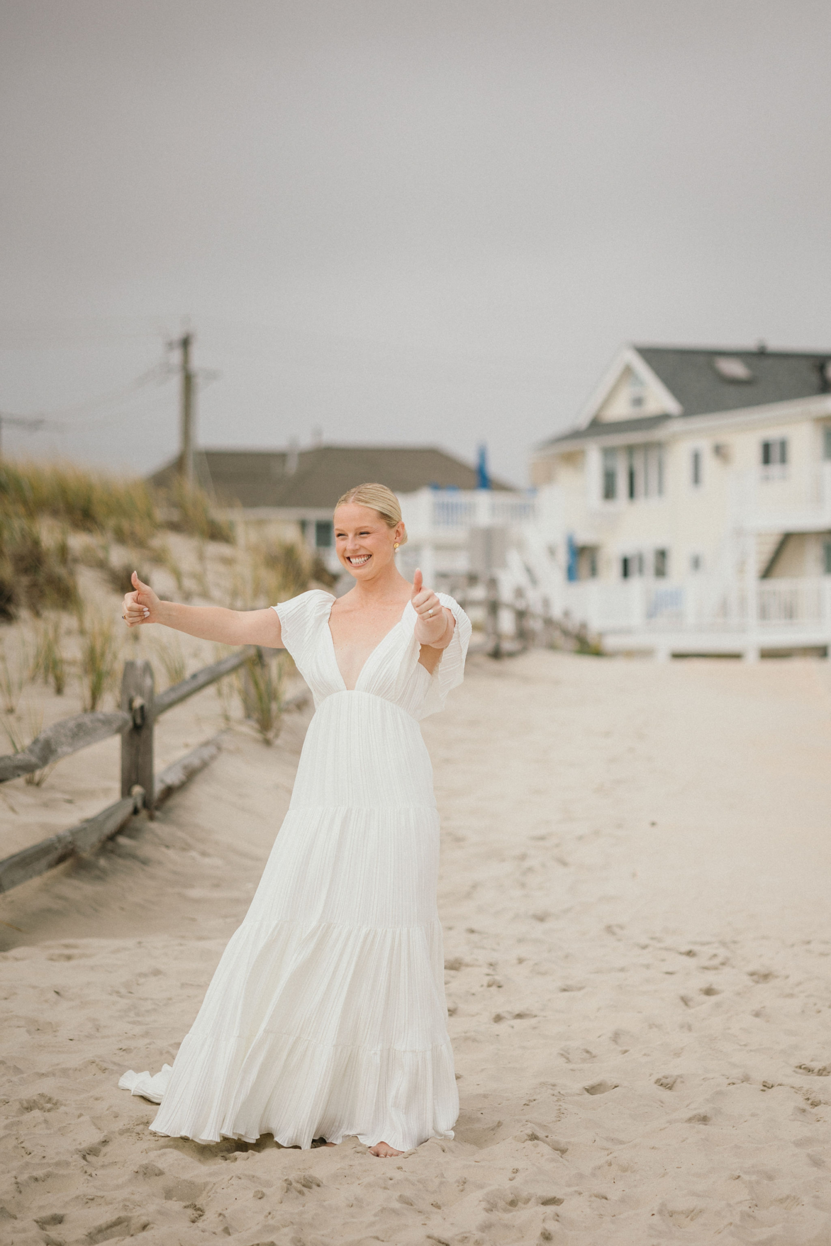 Bride walking up behind the groom on a sandy path for Ocean City, NJ wedding.