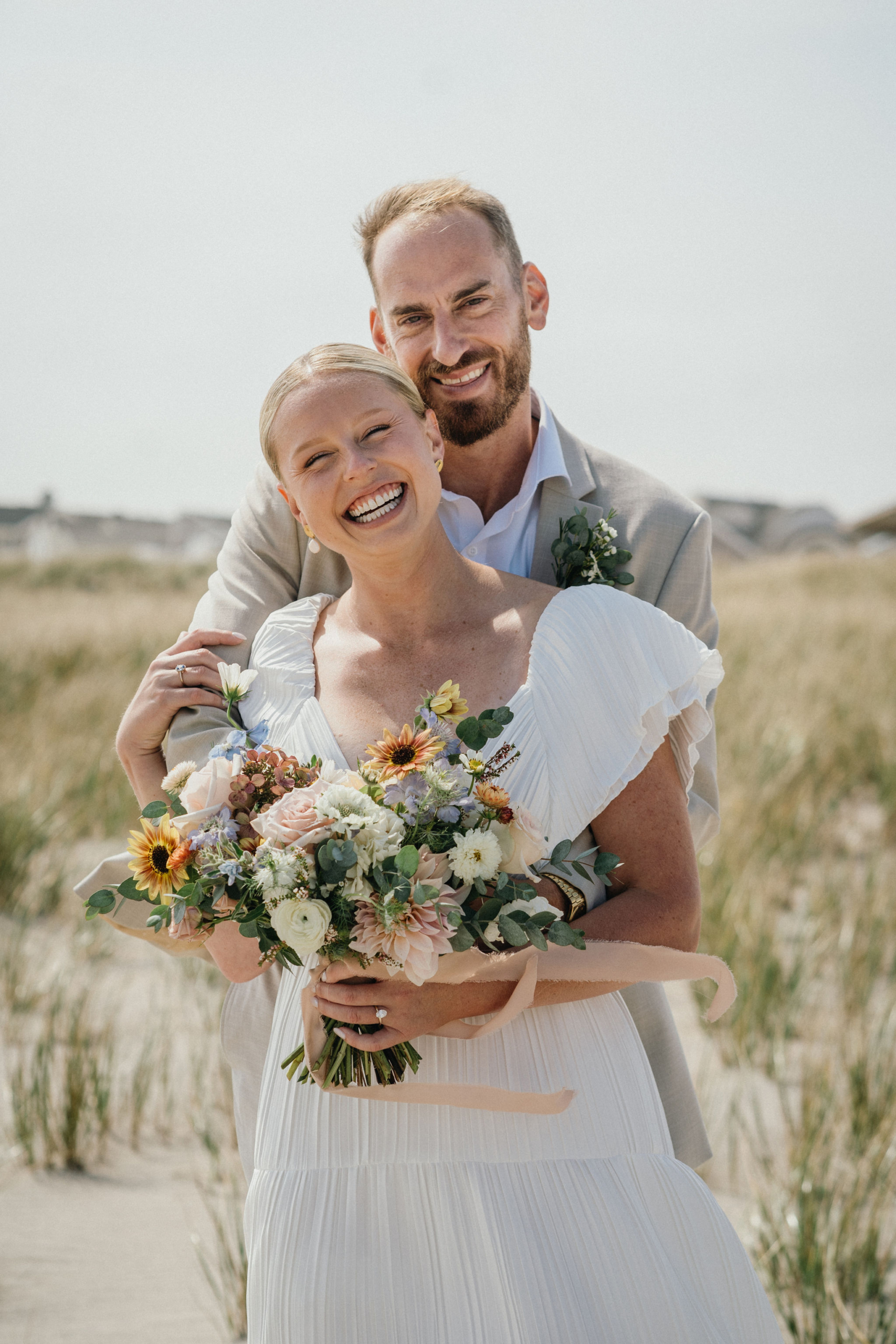 Newlyweds walking along the shoreline before their Ocean City, NJ wedding.