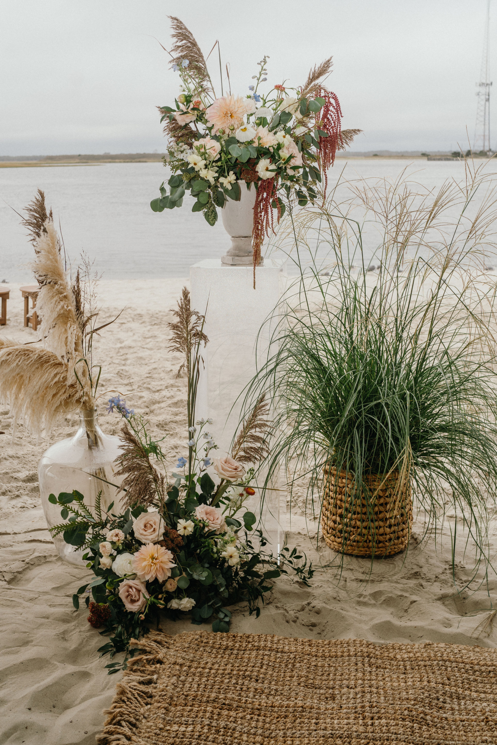 A dreamy boho setup with rattan, pampas grass, and ocean views.