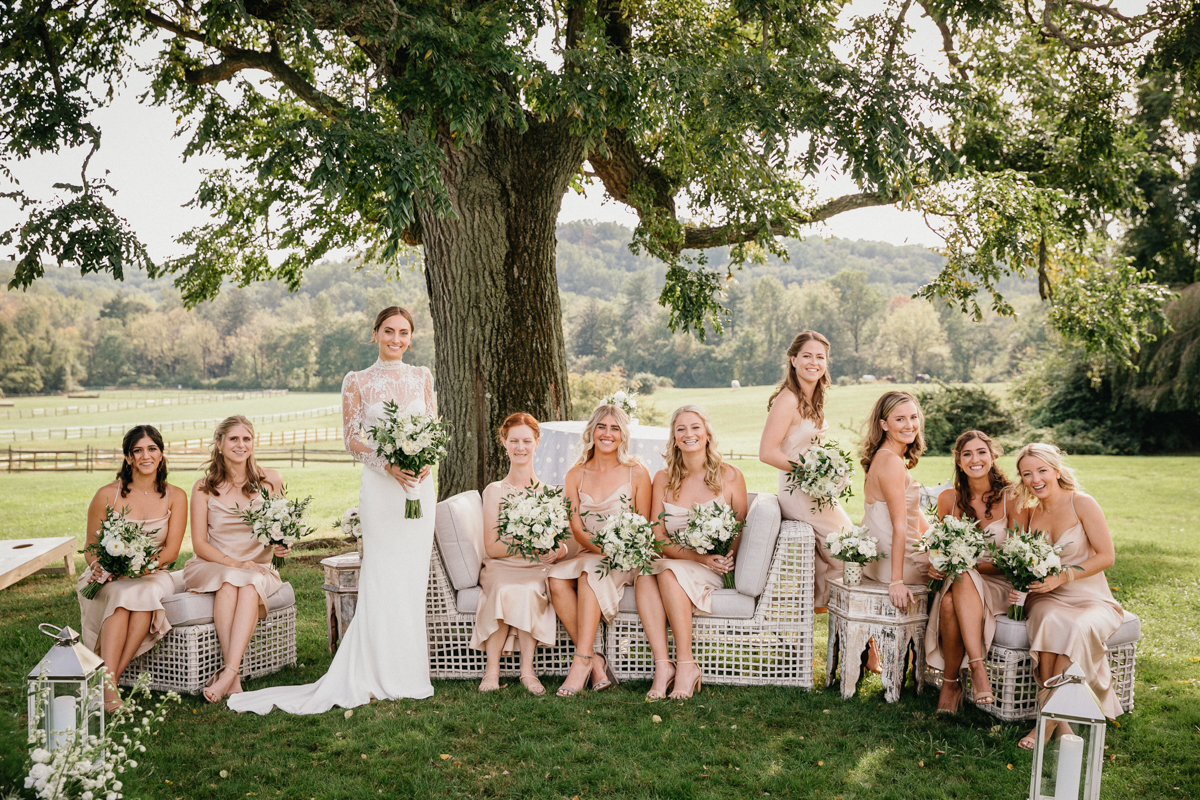 Editorial bridal party photo set outdoors at a historic estate wedding venue.