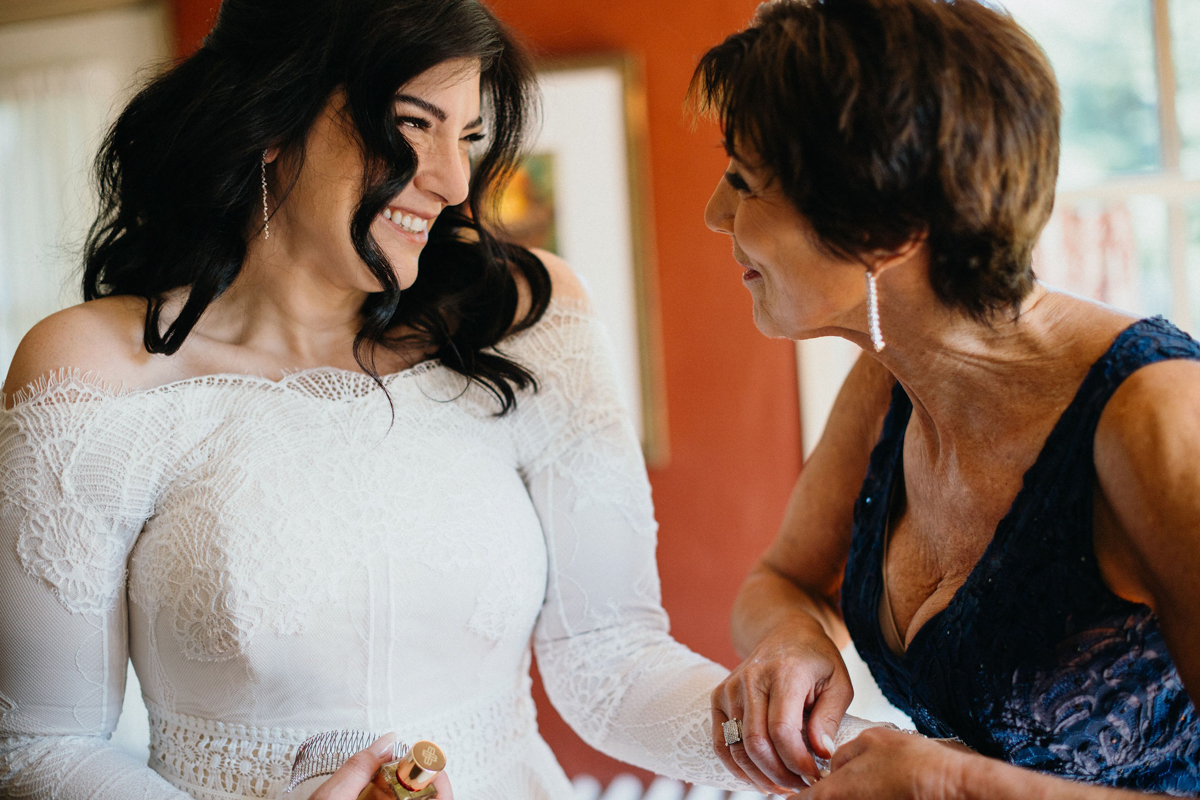 Candid moment between bride and her mother on the morning of her Grace Winery wedding. 