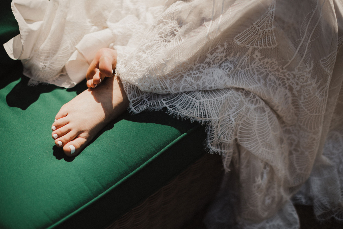 A vintage-inspired wedding gown catches the light at a Grace Winery wedding.