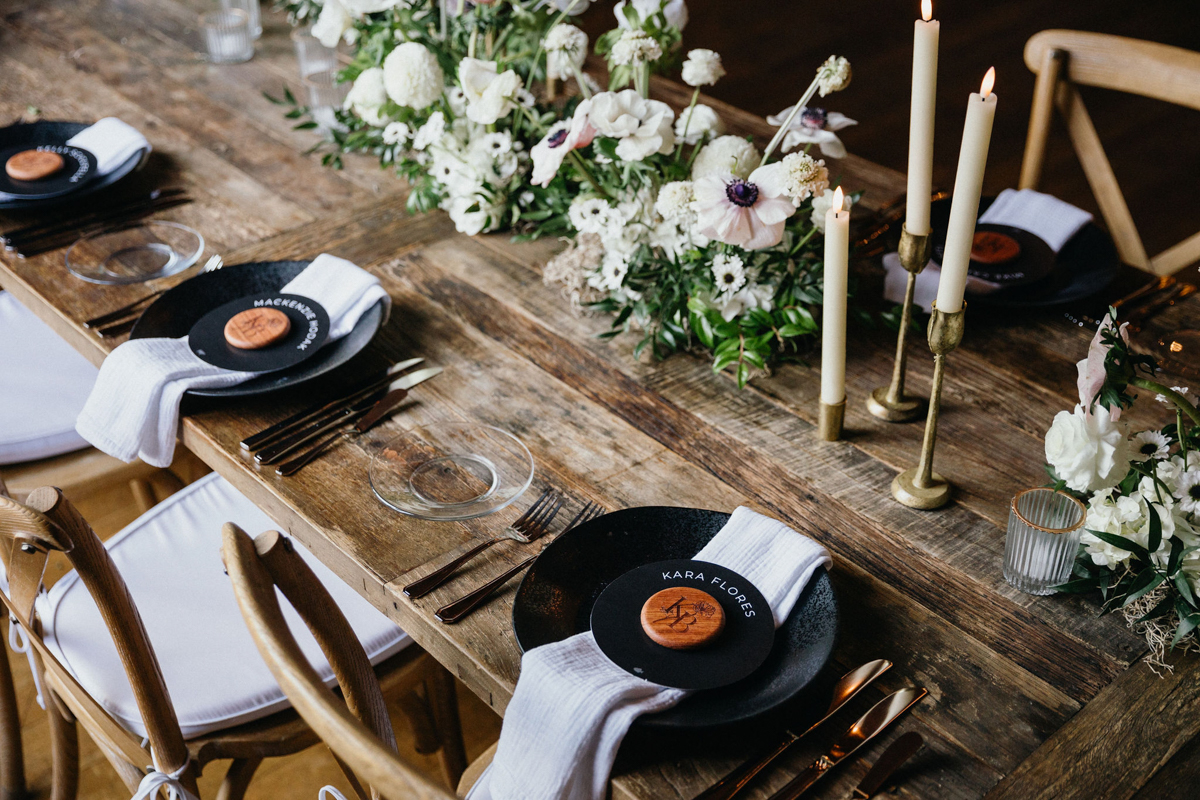 A beautifully set reception table with vintage glassware and floral centerpieces at the Inn at Grace Winery wedding. 