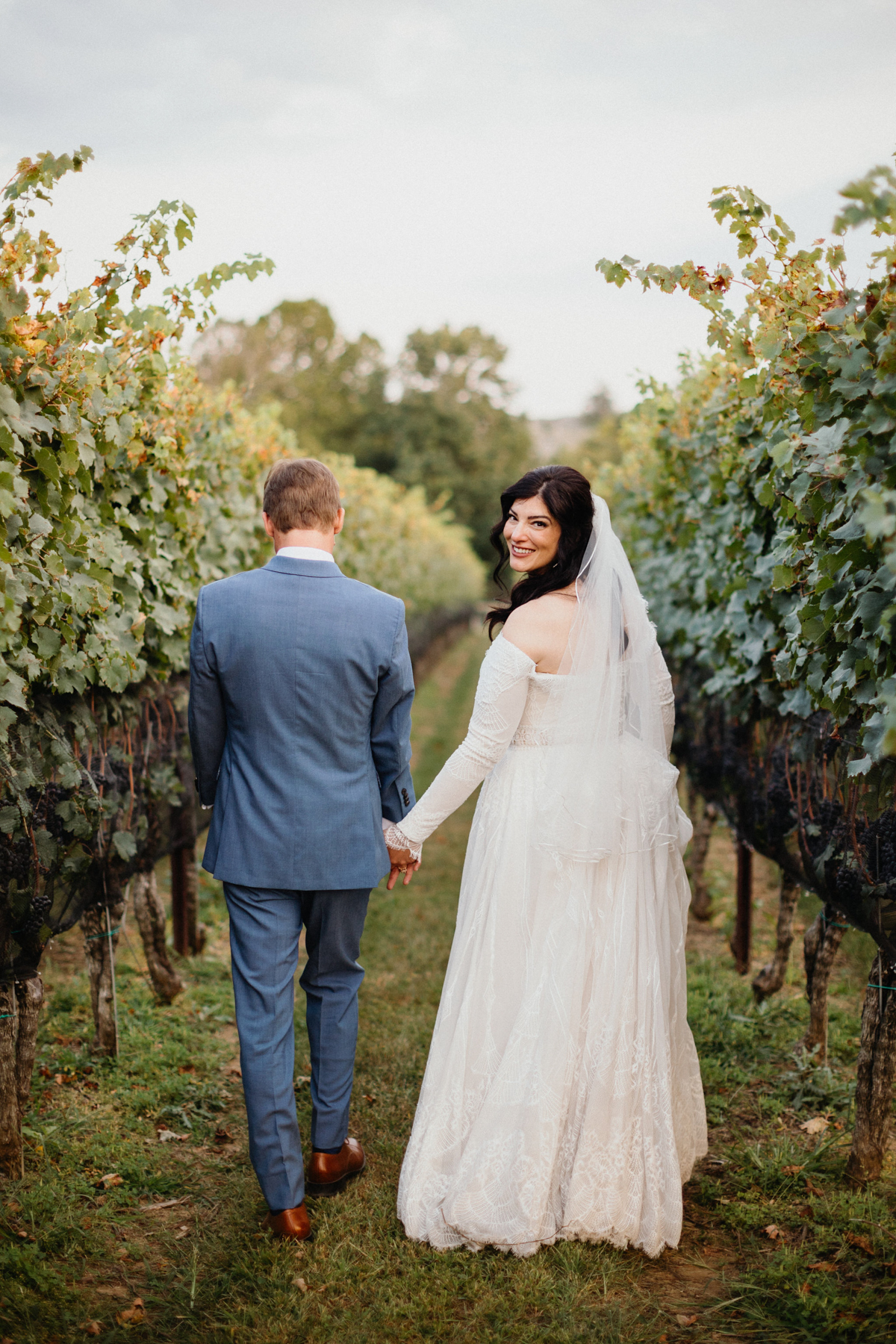 A peaceful first look in the vineyard at Grace Winery wedding. 