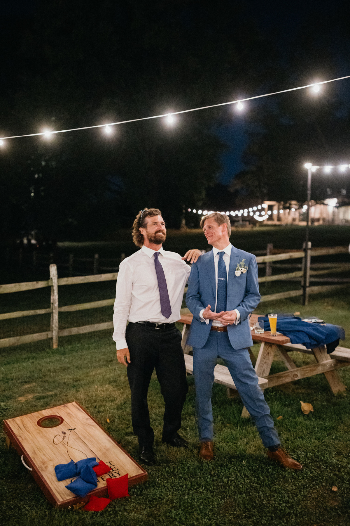 A rustic wooden cornhole set with custom wedding details.