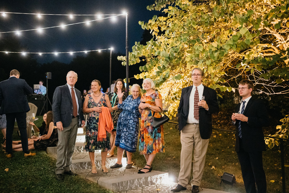 Vintage lanterns light up the lawn for a nighttime wedding game setup.