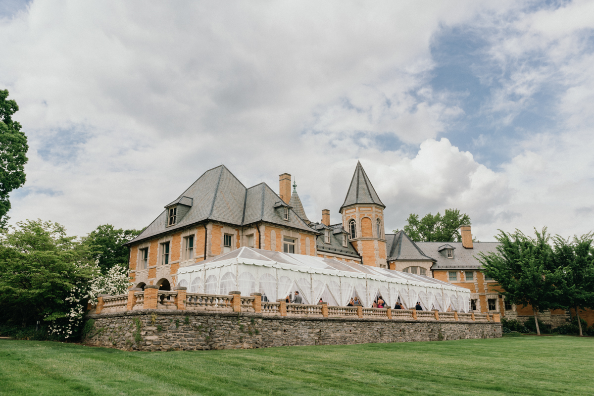 A vintage estate surrounded by towering trees and a secluded courtyard.