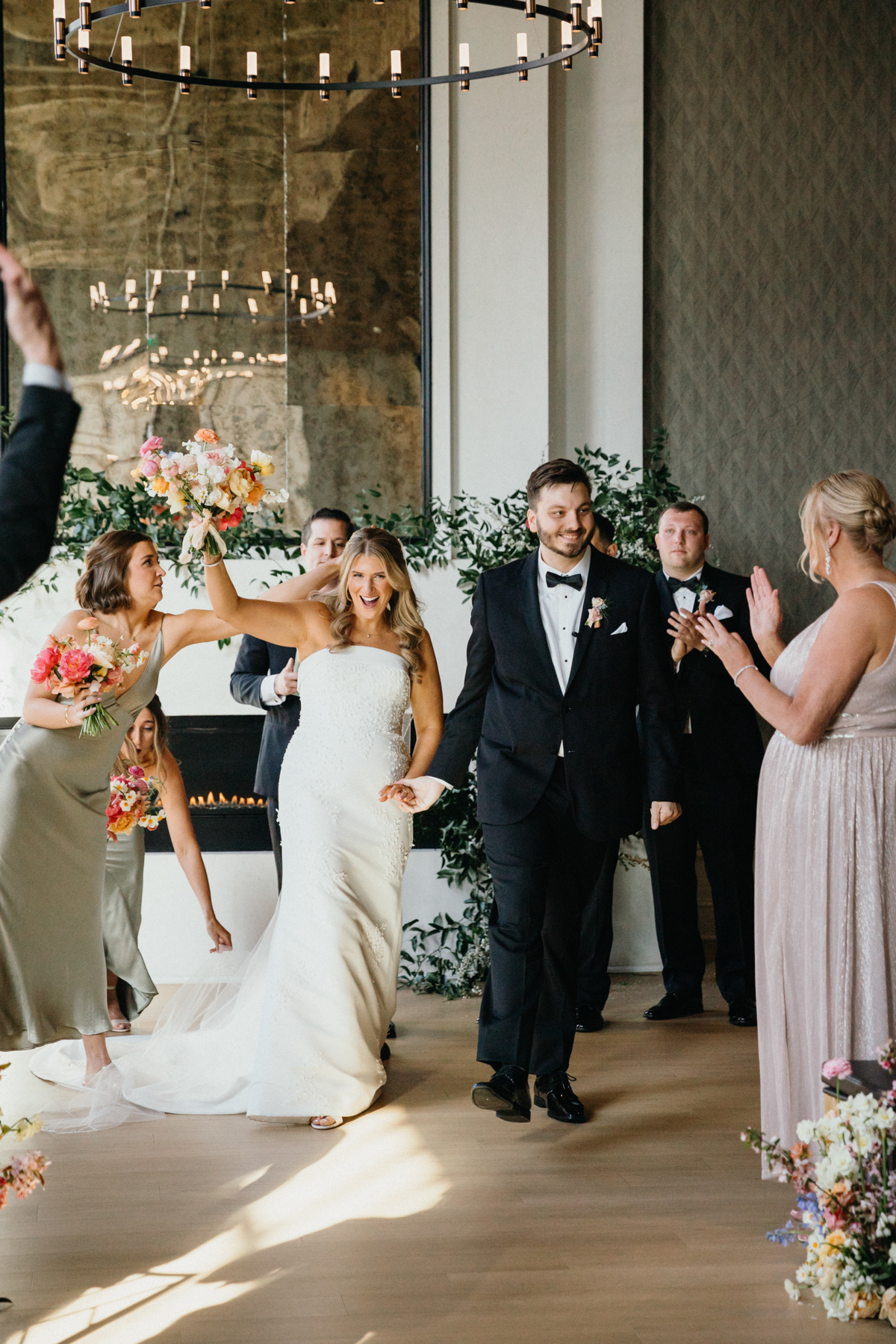 Candid photo of bride and groom exiting switch house wedding ceremony in philadelphia