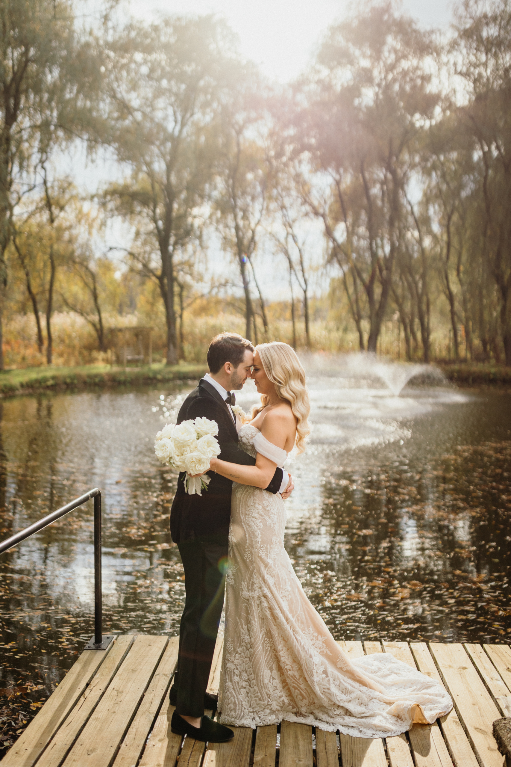 Sunlight filters through the trees as the couple shares a laugh during their Hotel Du Village wedding.