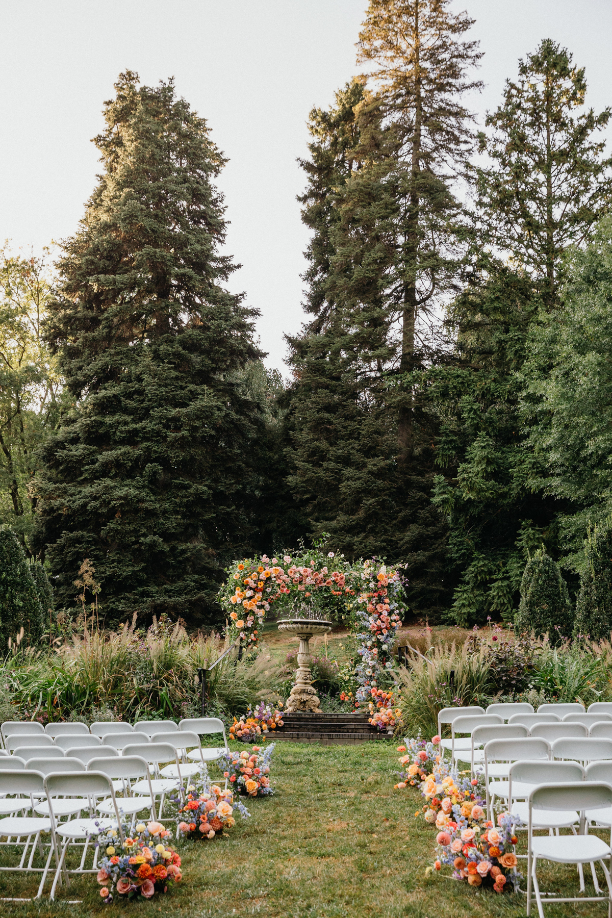 A lush floral arch at a Morris Arboretum wedding.