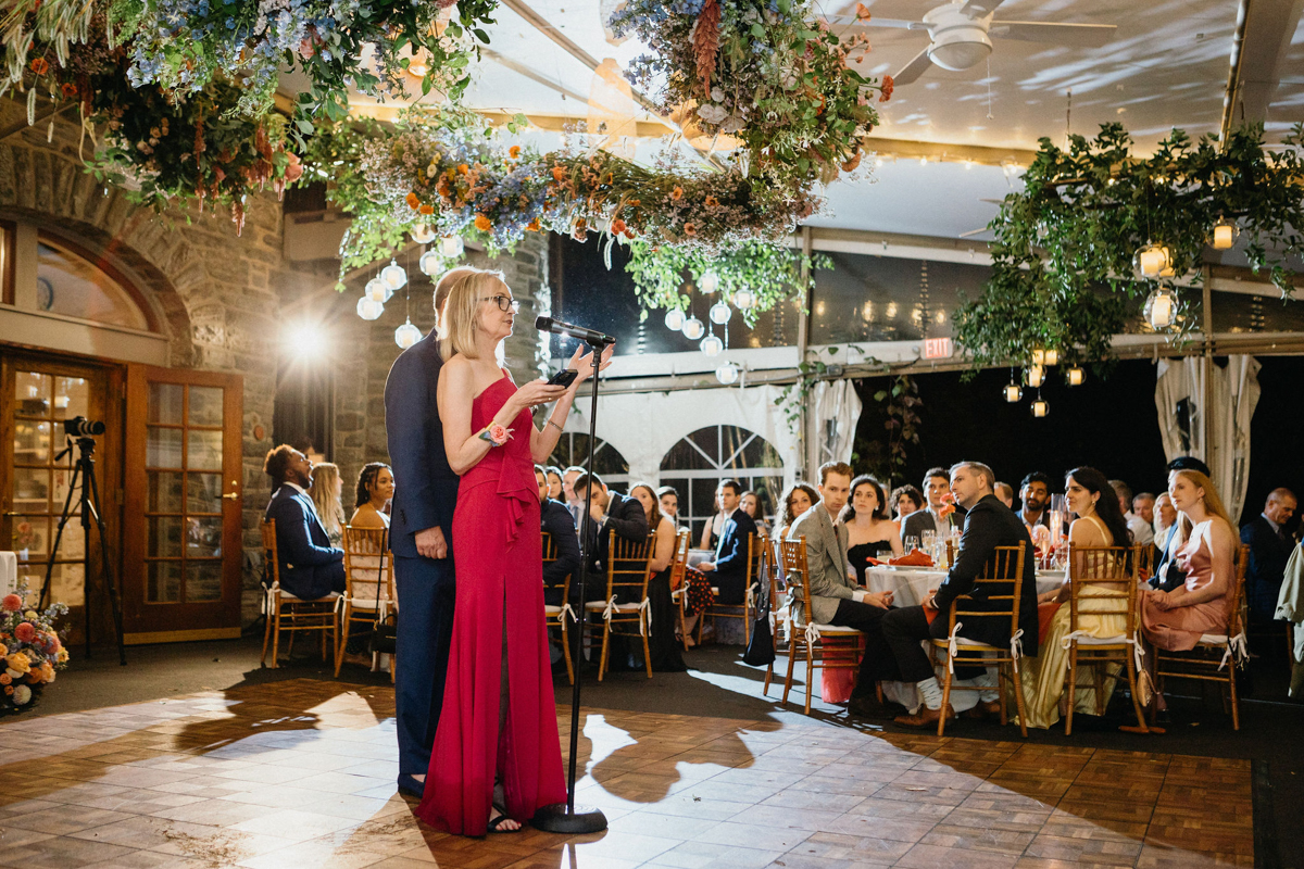 A first dance under twinkling lights at a Morris Arboretum wedding.