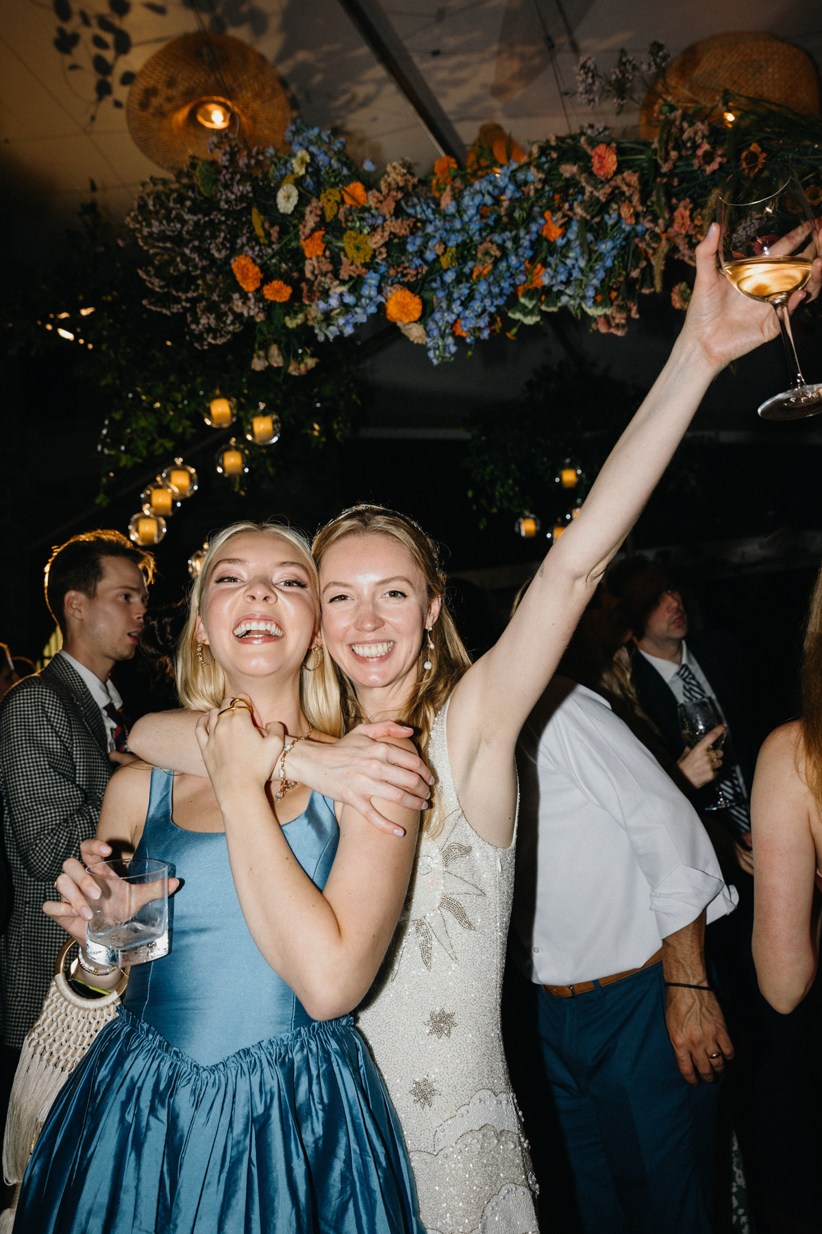 A couple celebrating with friends at a Morris Arboretum wedding.