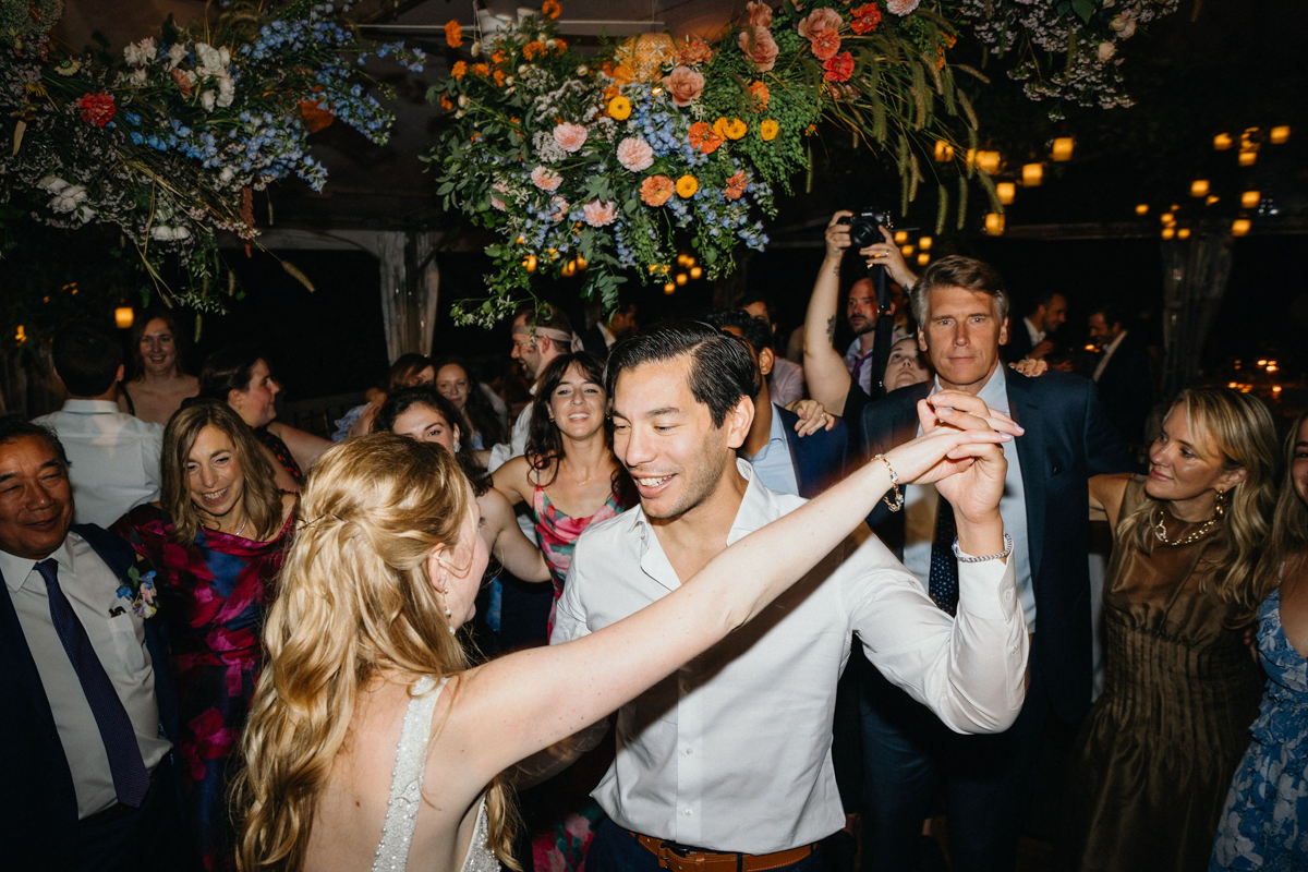 A couple twirling on the dance floor at a garden wedding venue in Philadelphia.