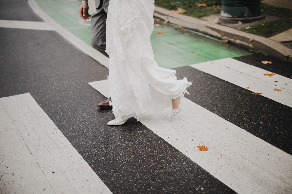 candid photo of bride and groom walking to their Morris Arboretum and Gardens wedding