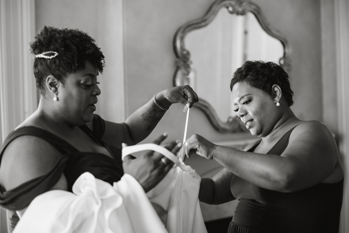 Candid moment in bridal suite with bride laughing – documentary wedding photography