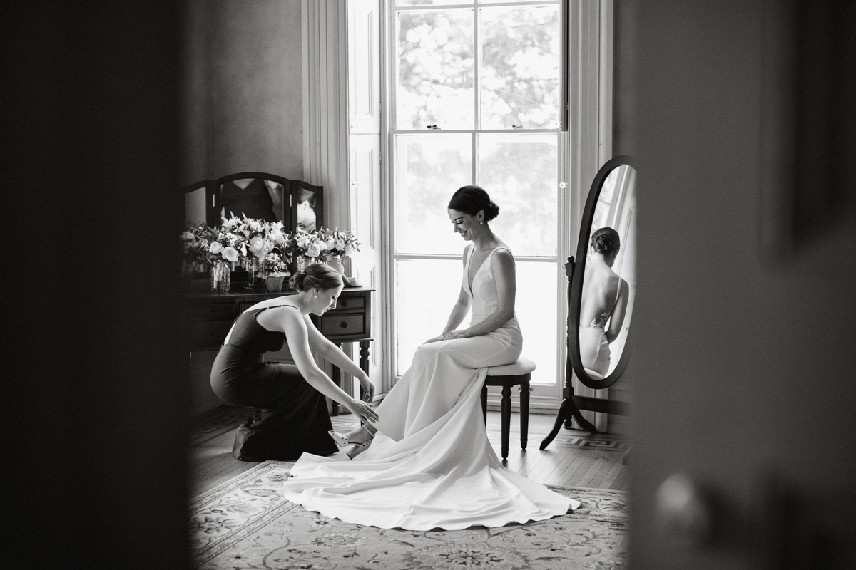 Candid moment in bridal suite with bridesmaids – documentary wedding photography