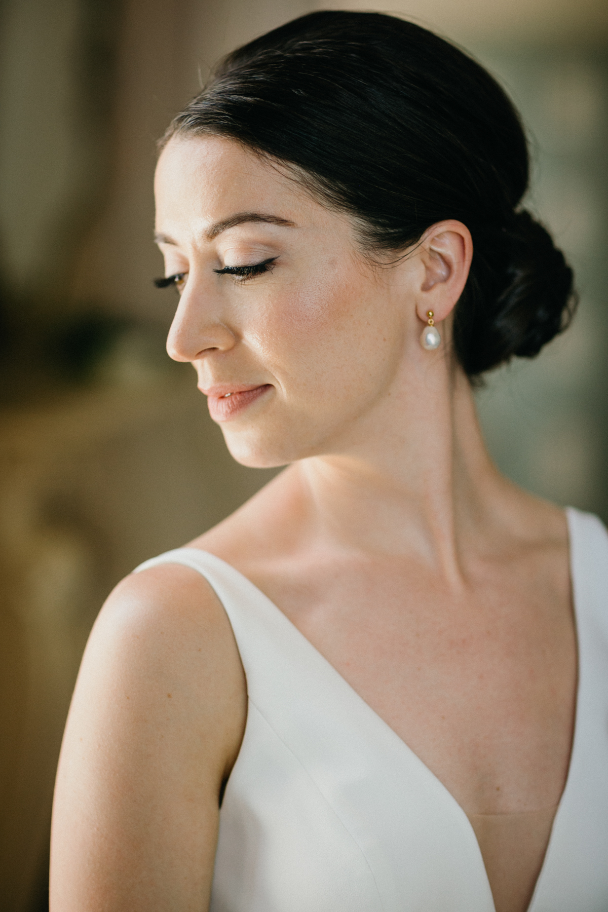 Bride standing by window in Glen Foerd bridal room – editorial wedding photography