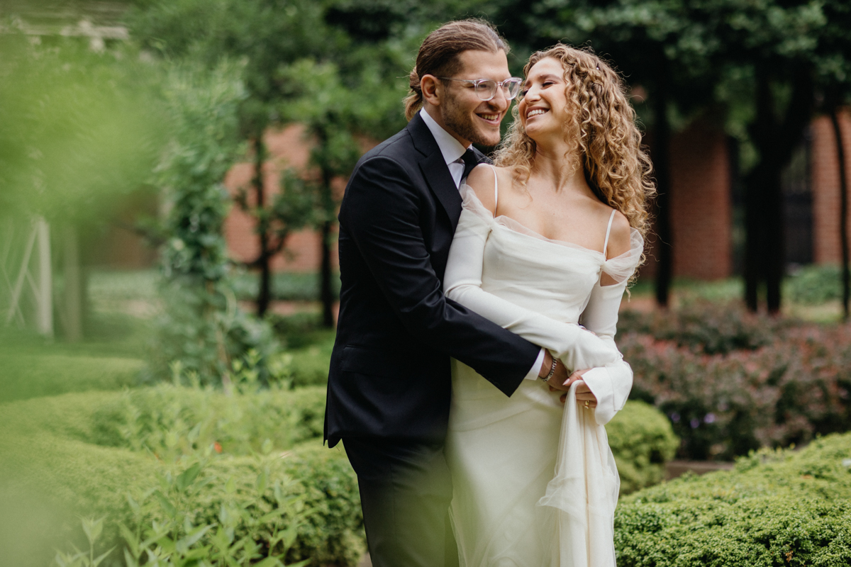 Bride and groom laughing together under the trees. – Candid photography, Philly wedding.