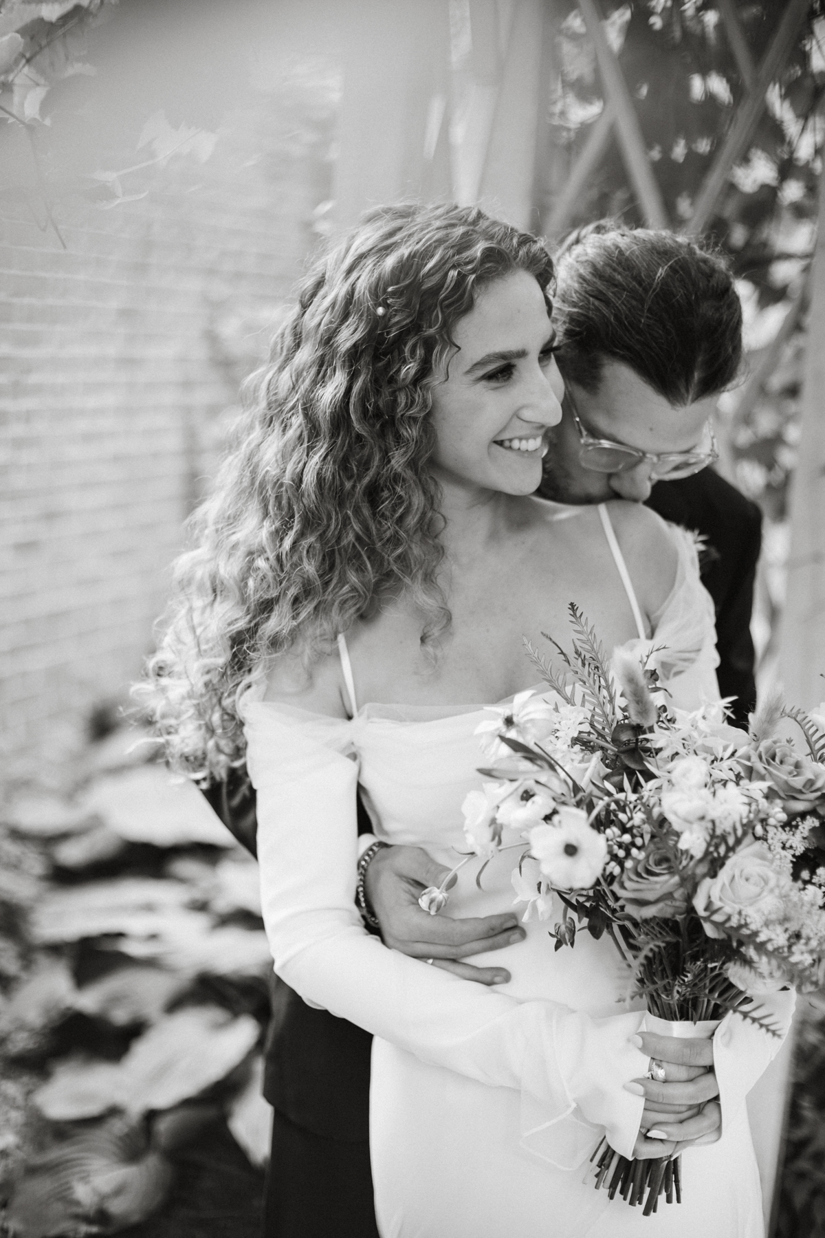 Romantic couple photos in front of brick walls and historic facades. – Philly wedding, candid photography.