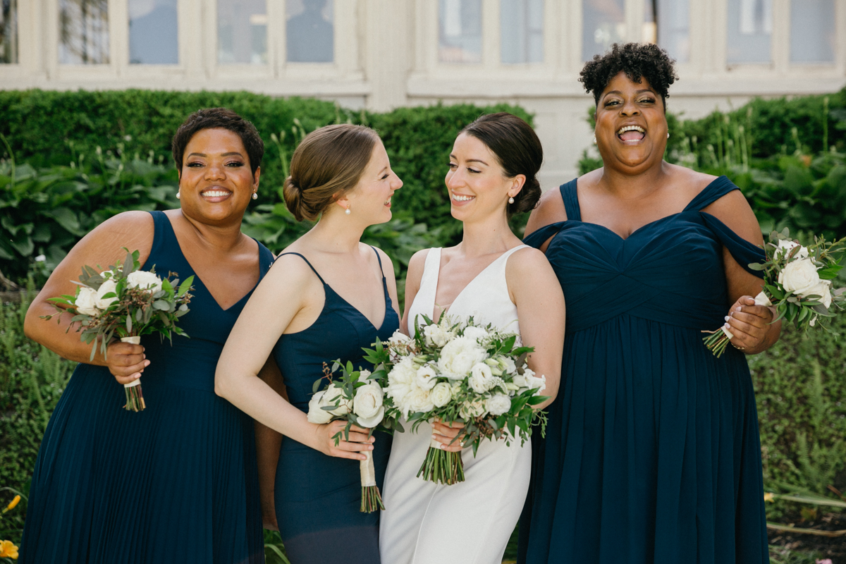 Bride laughing with bridesmaids – natural wedding photography