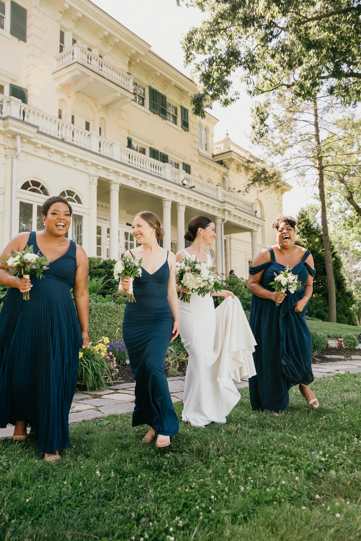 Bride laughing with bridesmaids – timeless wedding photography