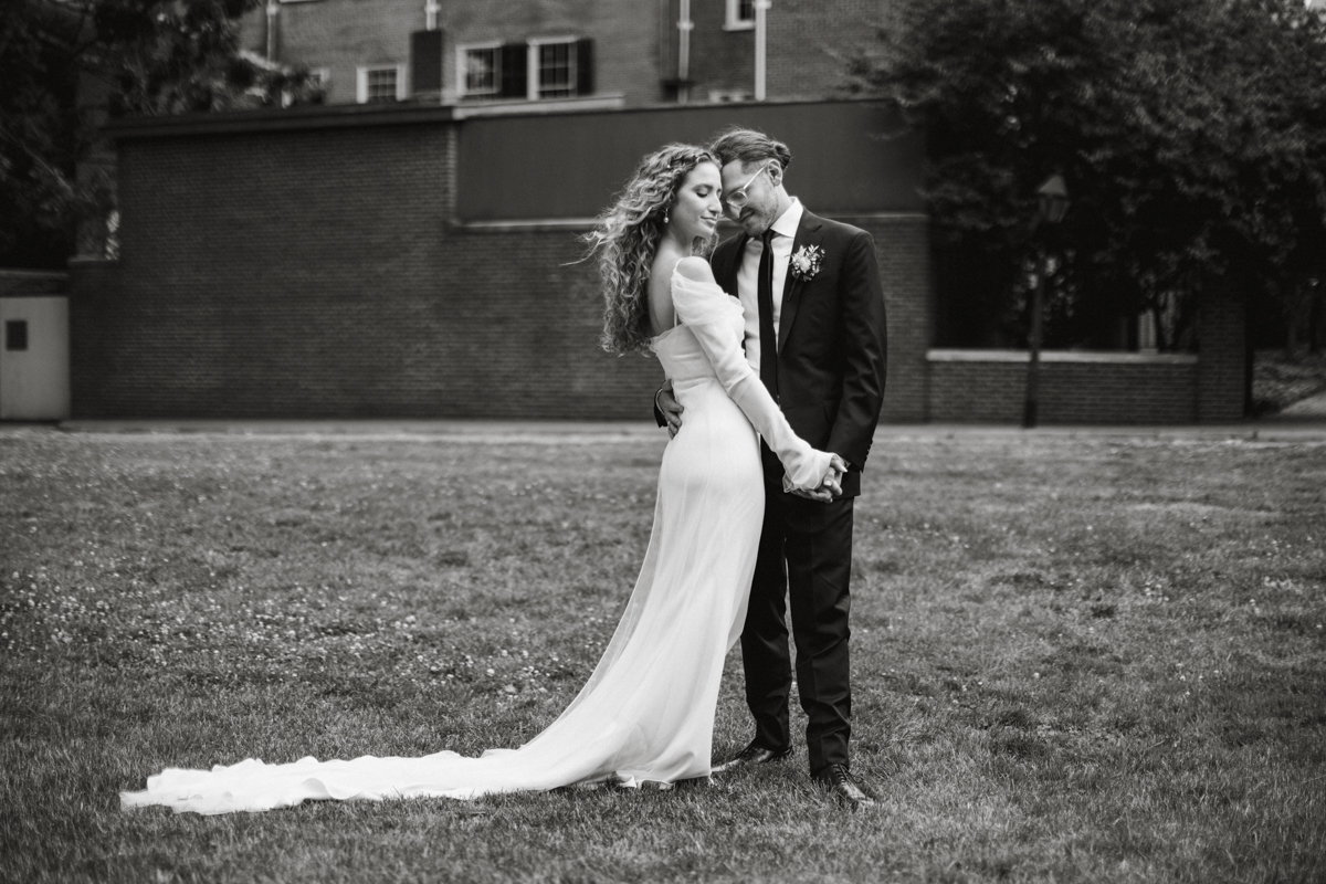 Romantic couple photos in front of brick walls and historic facades. – Philly wedding, candid photography.
