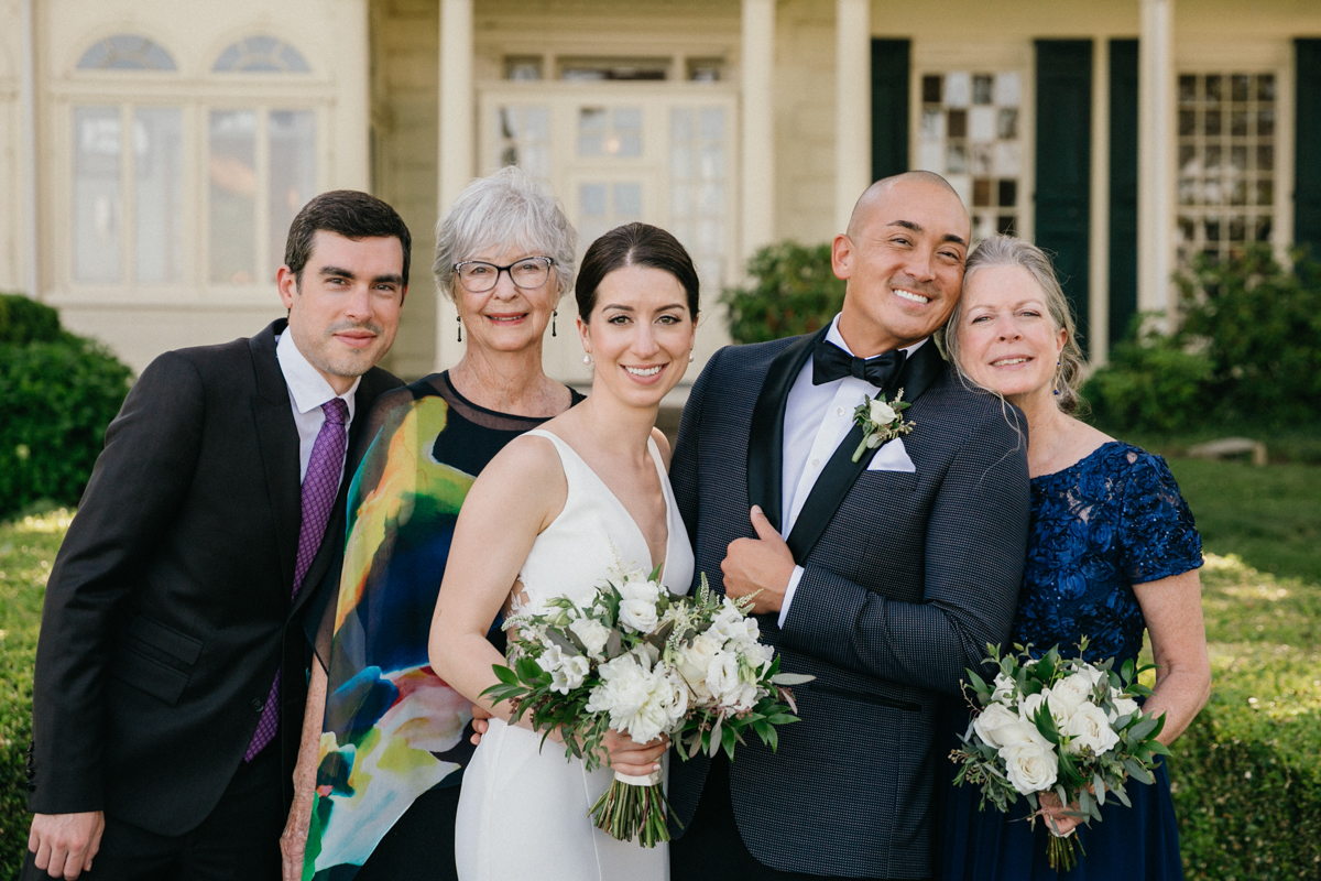 Couple with immediate family on Glen Foerd lawn – Philadelphia wedding photographer