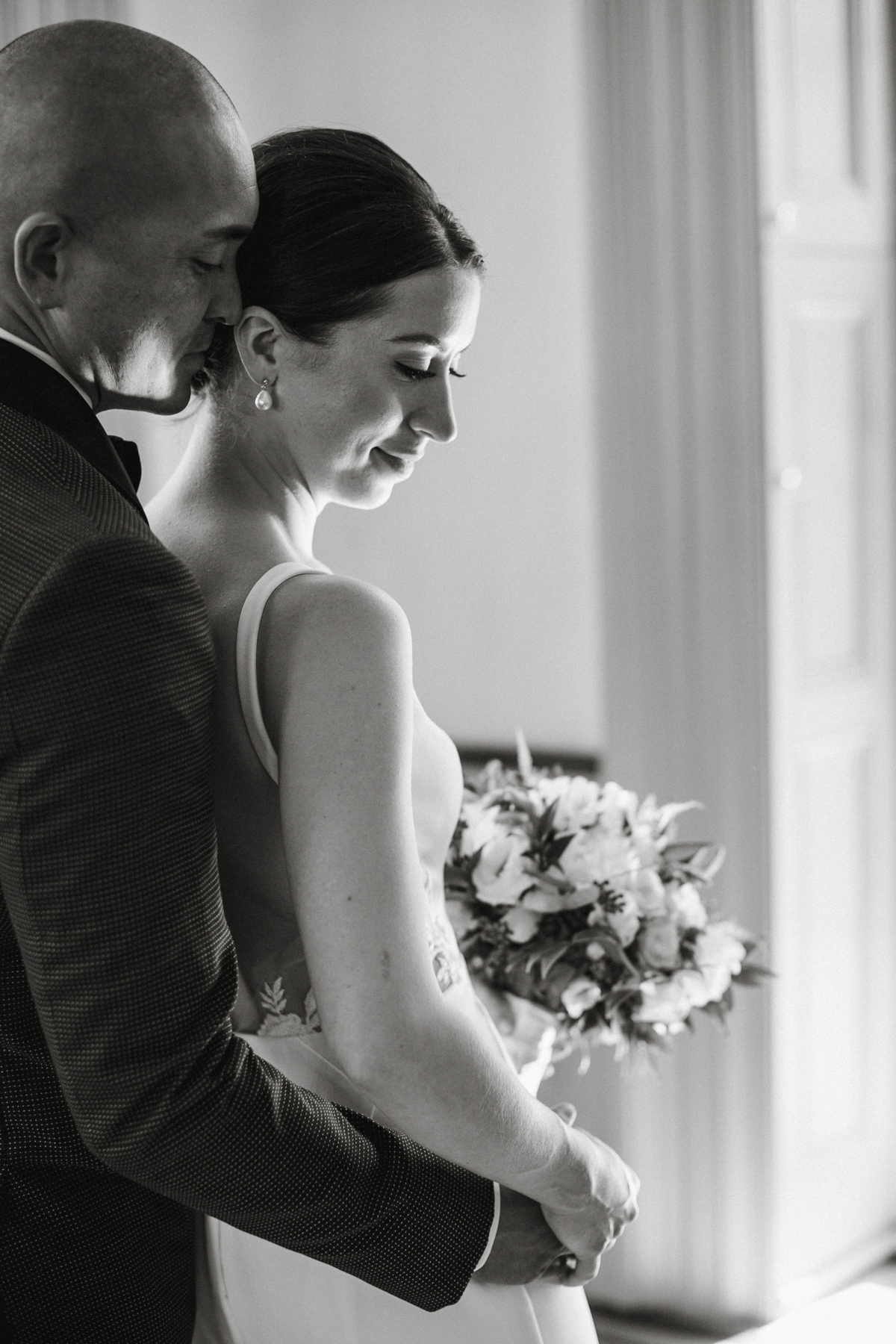 Interior couple portrait with chandelier and wood-paneled walls – Philadelphia wedding photographer