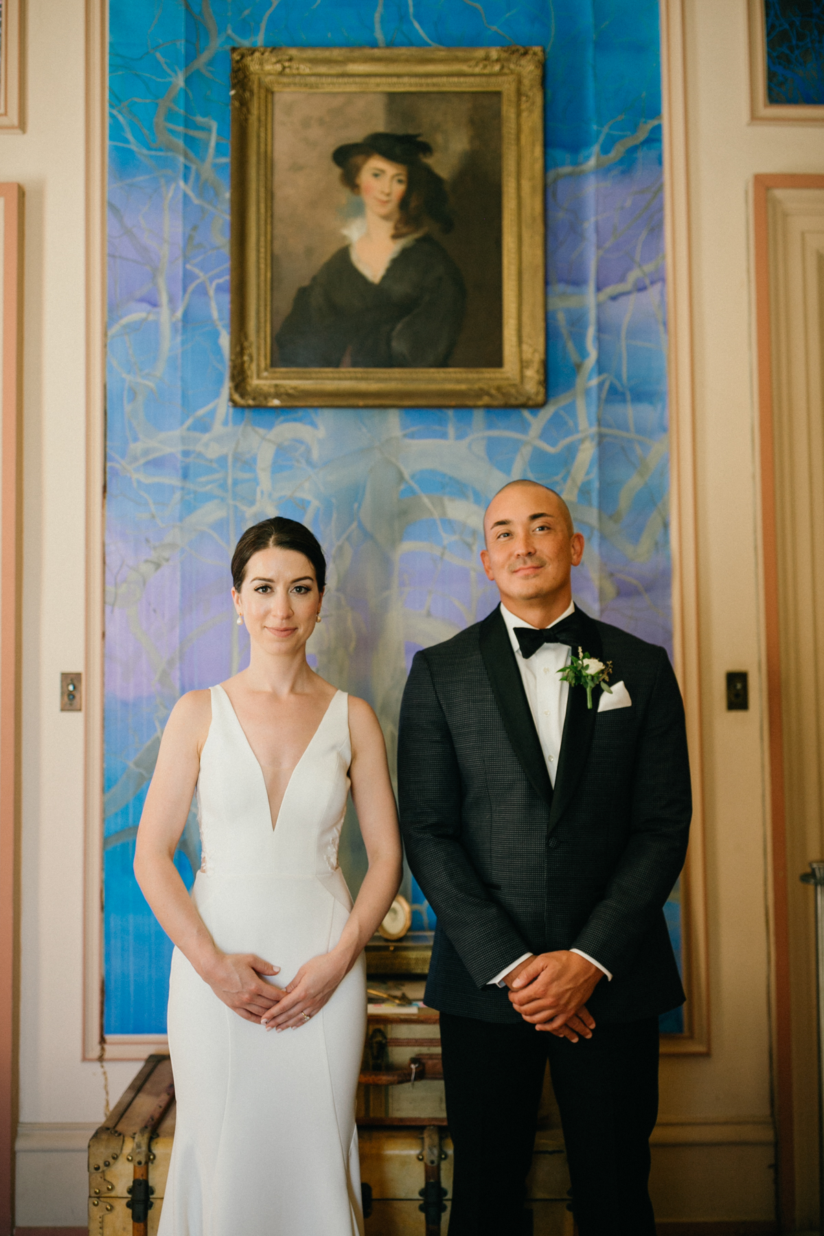 Couple framed in front of art – editorial wedding photography at Glen Foerd