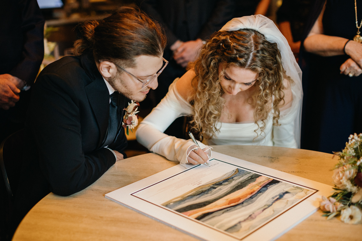 Signing moment with joyful expressions – Zahav wedding in Philadelphia, documentary photography