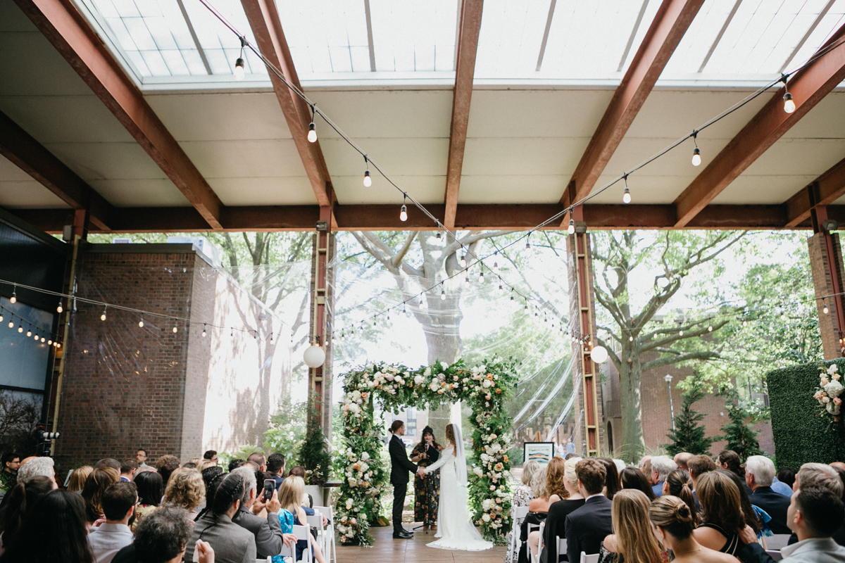 Wide ceremony view with floral arch and city backdrop – Zahav wedding in Philadelphia, restaurant wedding venue in Philadelphia