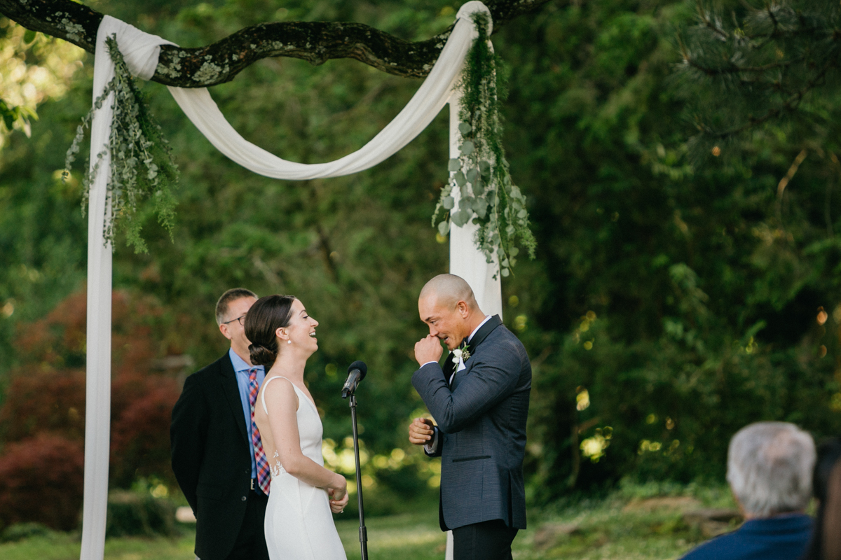 Emotional vow moment beneath garden canopy – Philadelphia wedding photographer