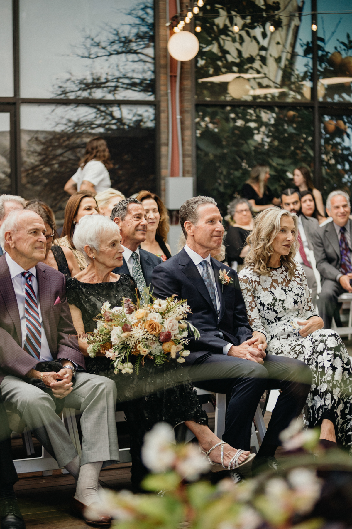 Guests watching ceremony on the sunlit patio – Candid photography, Philly wedding