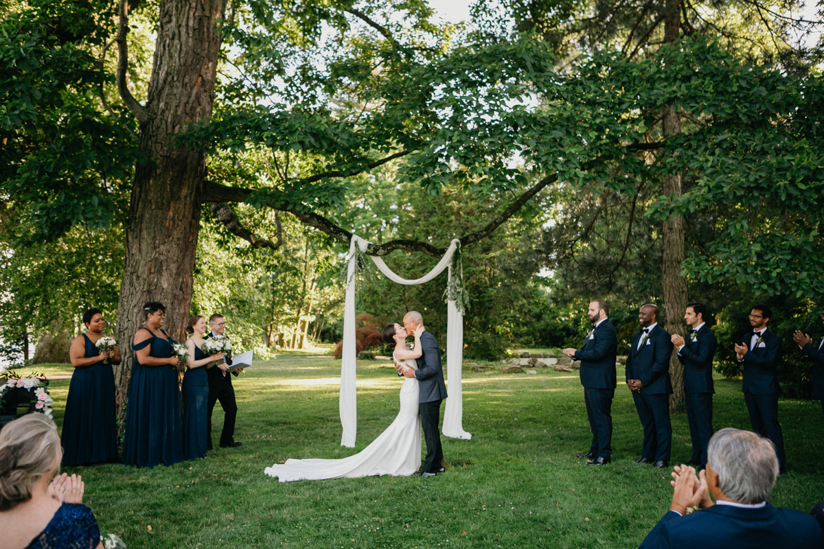 Garden ceremony with dappled sunlight through the trees – Pennsylvania wedding photographer