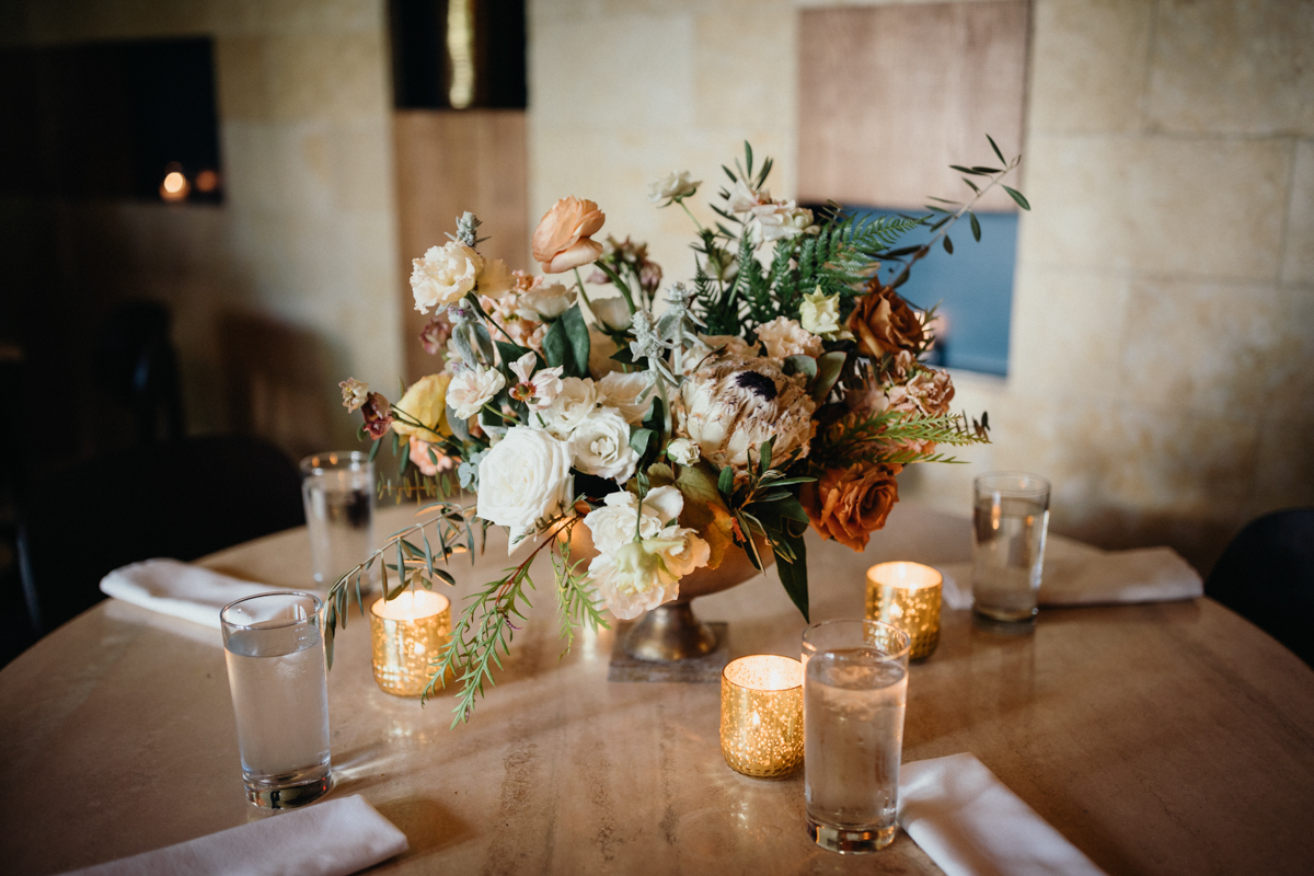 Floral centerpiece and candlelight at Zahav tables – Editorial photographer, restaurant wedding venue in Philadelphia