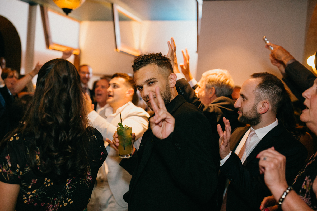 Guests letting loose on the dance floor during the energetic reception – Restaurant wedding venue in Philadelphia, documentary photography