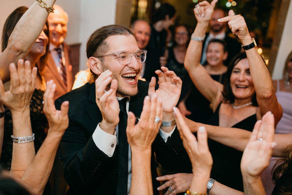 groom laughing and dancing at Zahav wedding shot by Philadelphia photographer