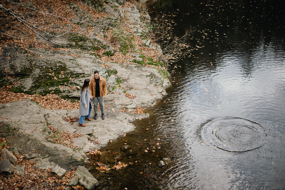 Wissahickon engagement session with soft autumn color - skipping rocks