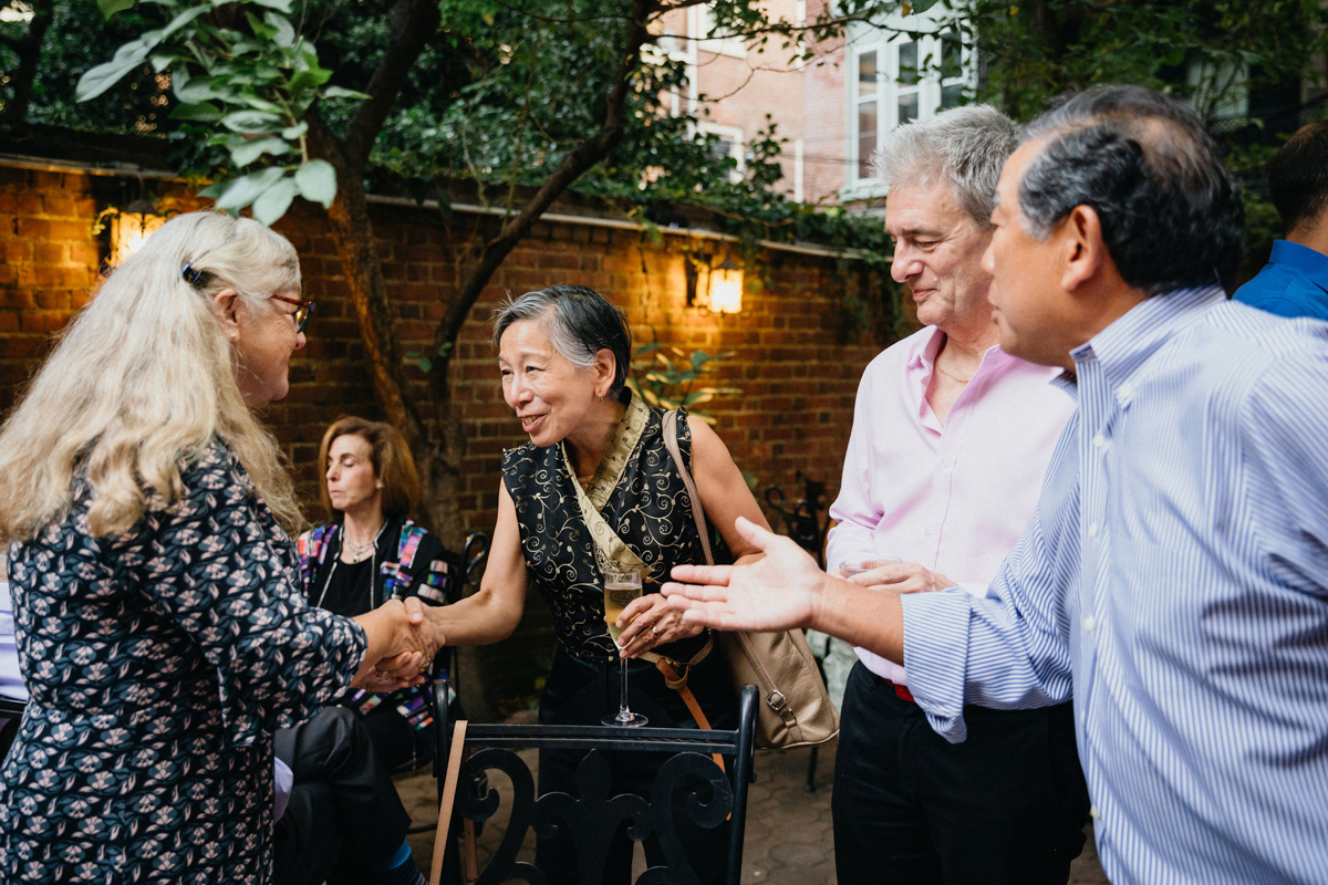 Couple mingling with guests inside More Behind the Door