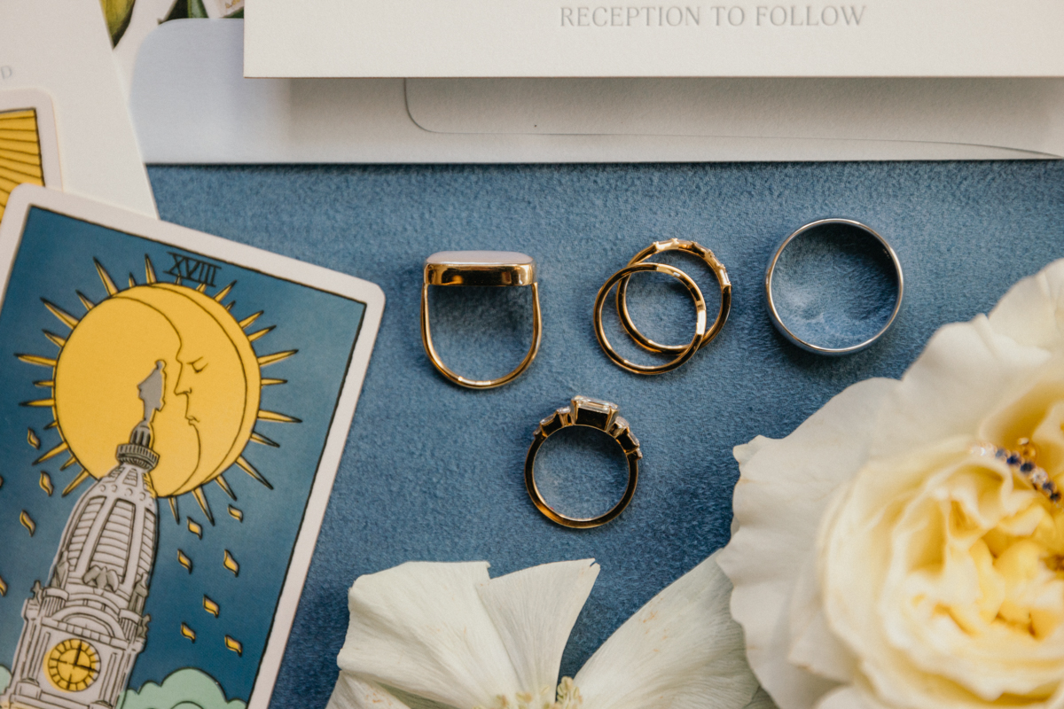 Wedding rings and vow books photographed before the ceremony