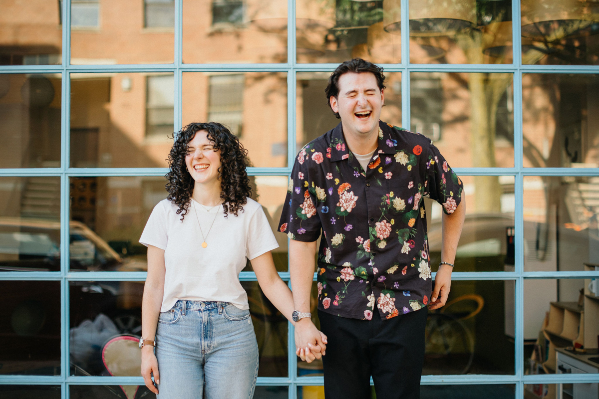 Engagement photos with the couple casually posing in the streets of the city - philly