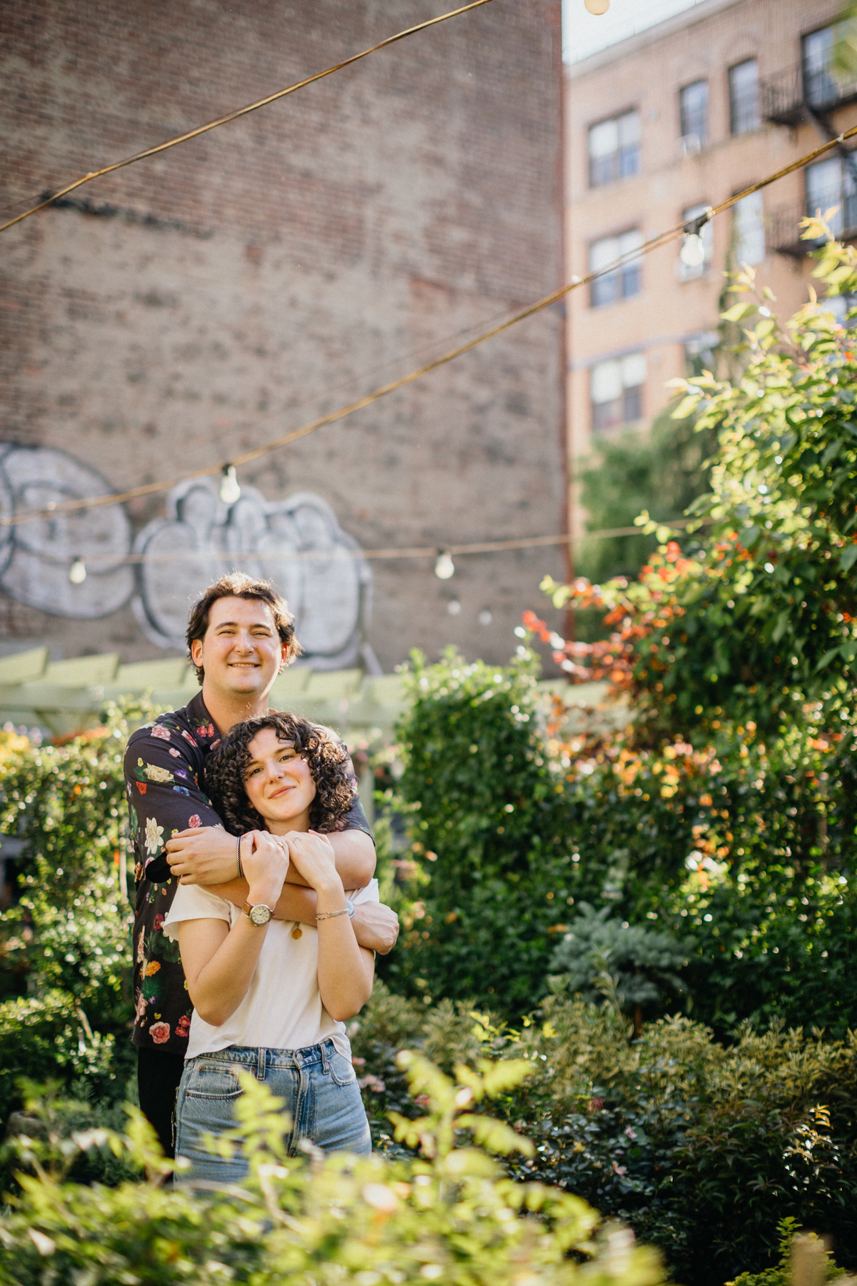 Brooklyn engagement session featuring a couple in trendy outfits with a city backdrop.