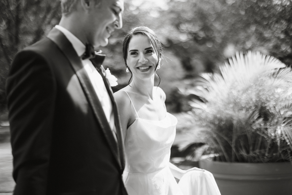 Candid bridal photo surrounded by greenery at the Horticulture Center