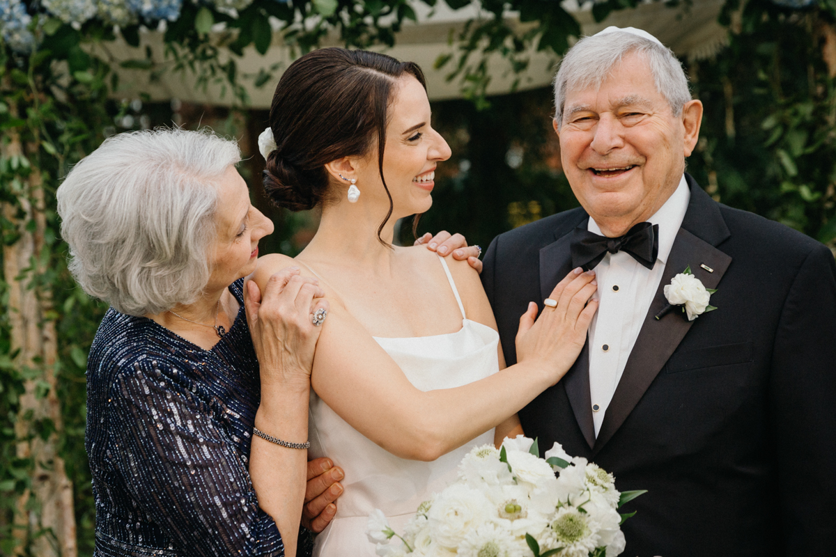 Bride hugging a family member during wedding day celebrations