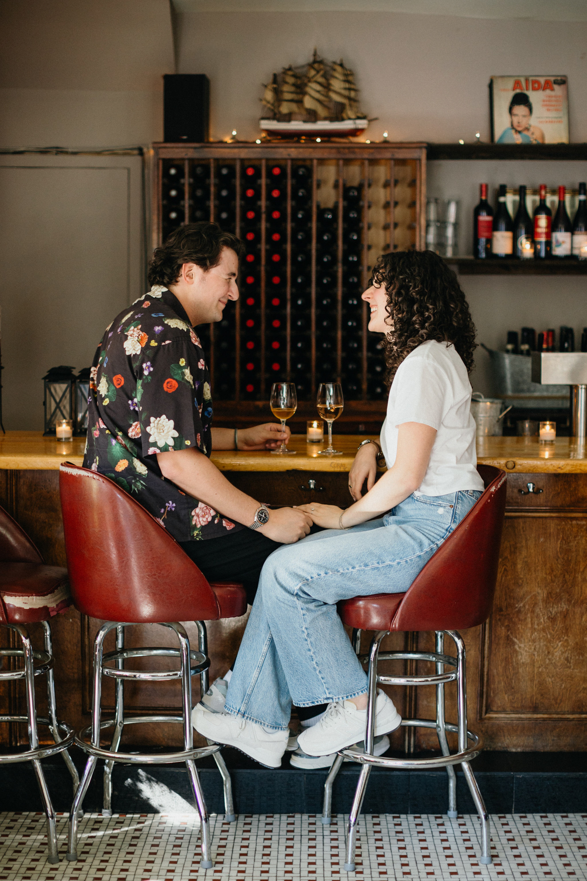 Couple enjoying drinks at Pinkerton Wine Bar during their Brooklyn engagement session.