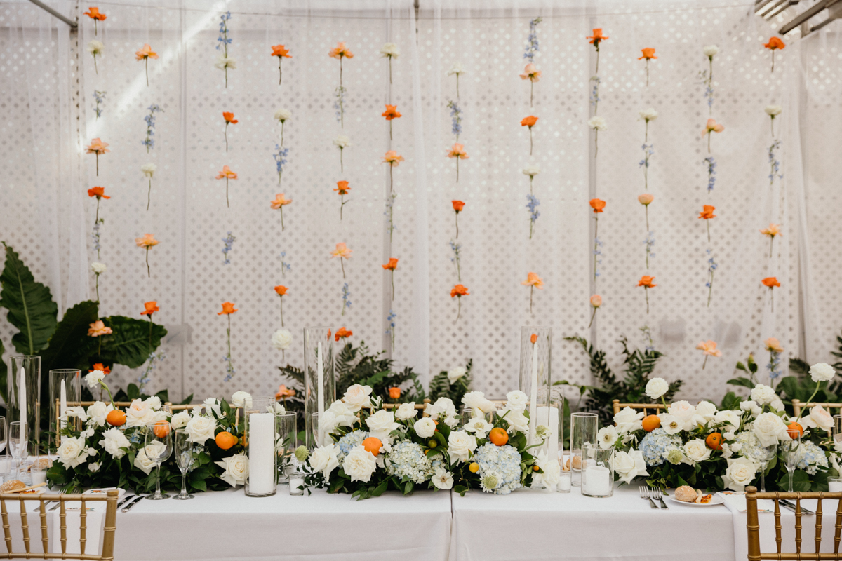 Long tables with lush florals and candles at the Horticulture Center wedding