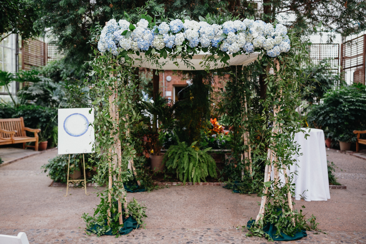 Floral chuppah inside the Horticulture Center greenhouse
