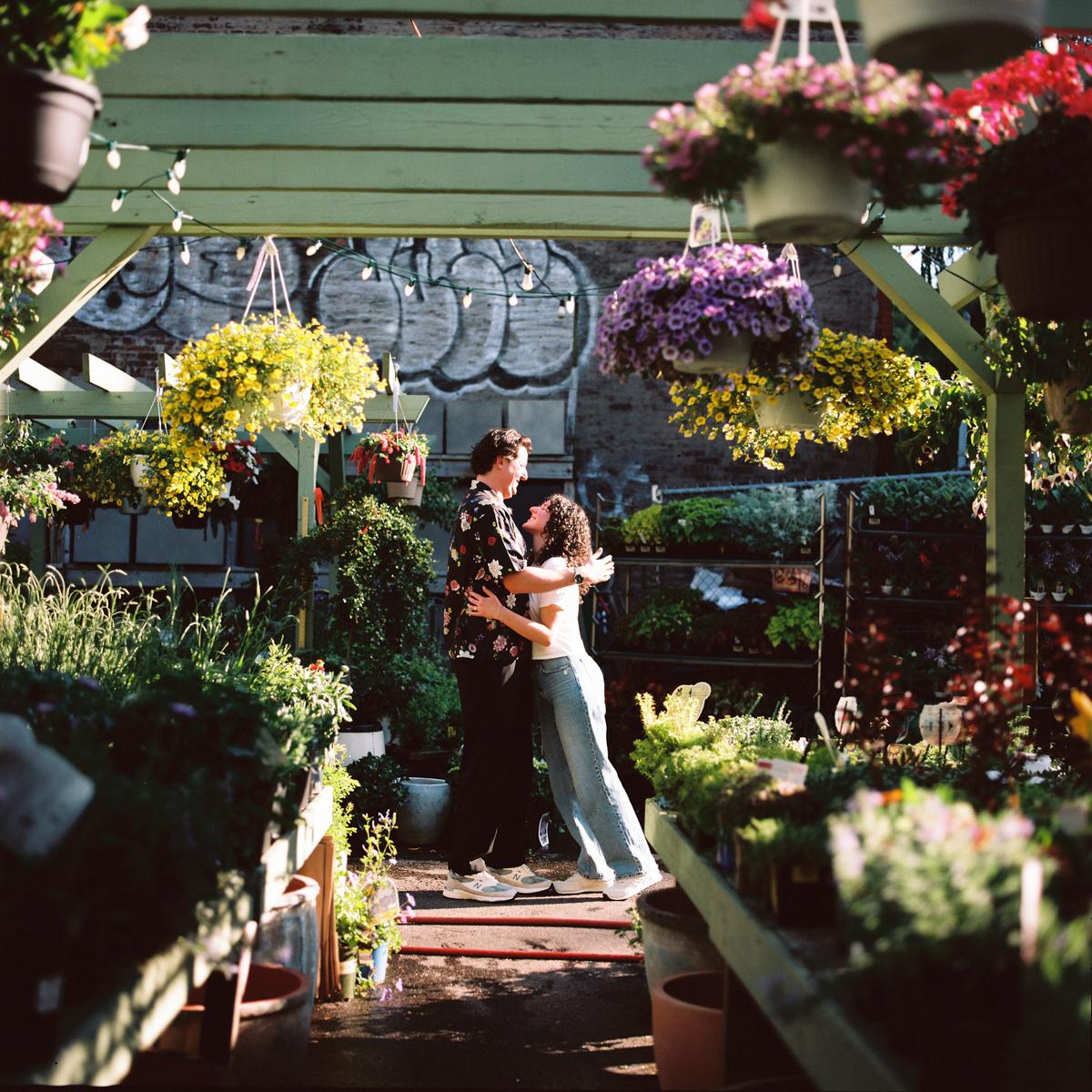 A couple laughing in Brooklyn's gardens, photographed on medium format film.