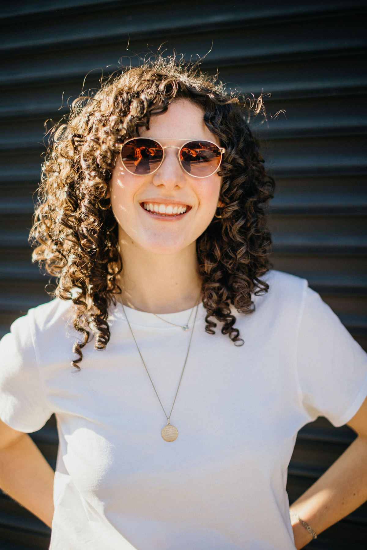 Close-up of the couple’s outfits in NYC engagement photos, styled with sunnies and casual wear.